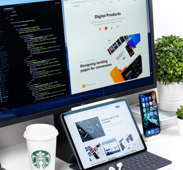 Developer desk with code and responsive UI mockups on monitor, tablet, and phone — custom software development in UAE by AiVIZ